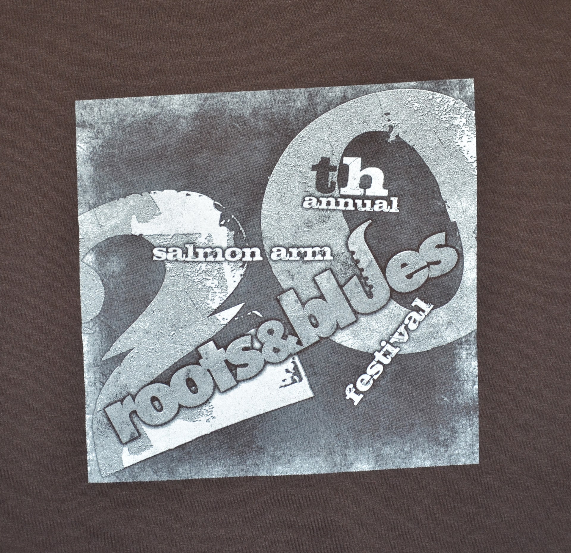 Brown t-shirt featuring the phrase "rooting for roots" in bold lettering.