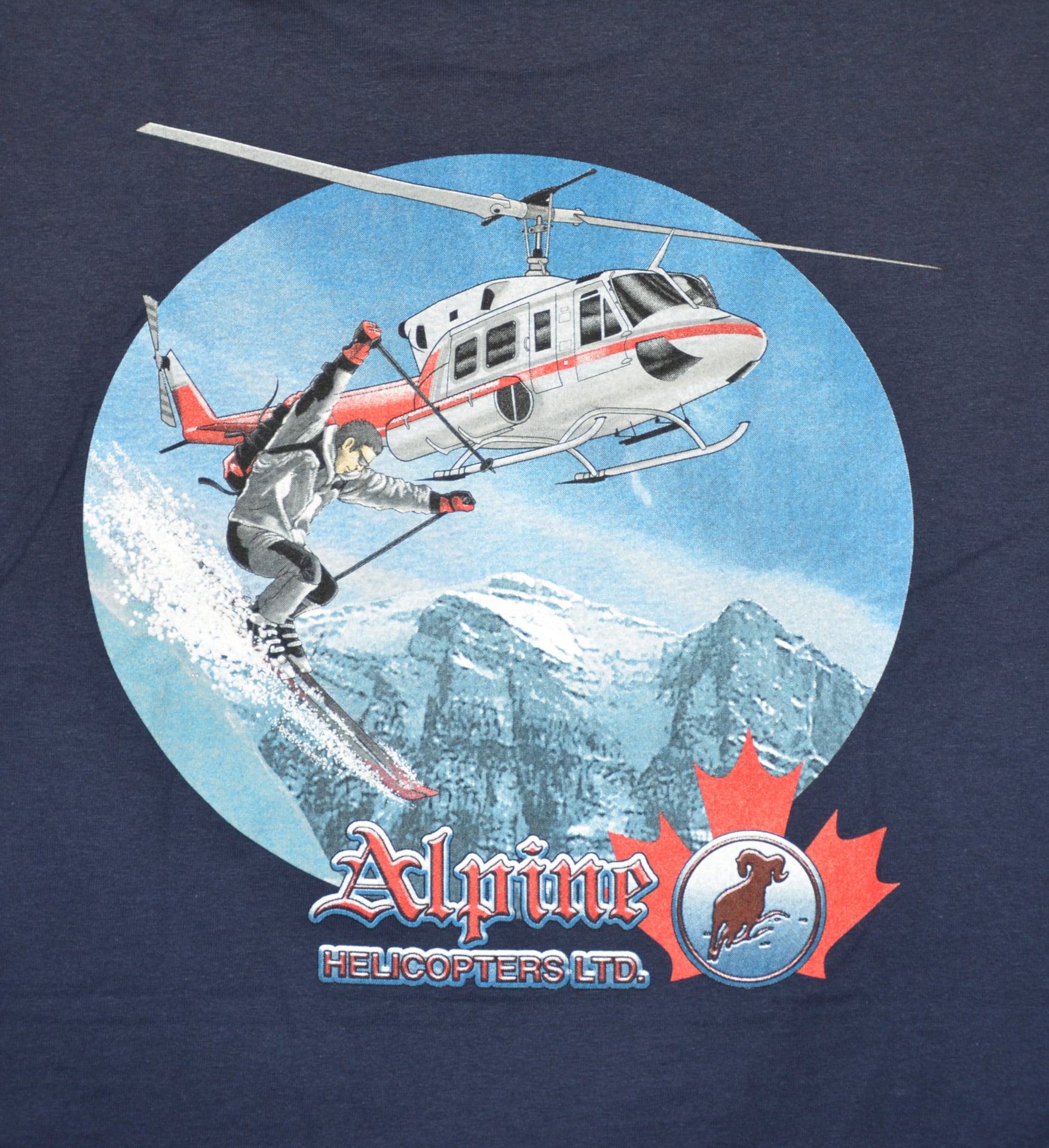 A t-shirt featuring a graphic design of an adventure ski resort, showcasing mountains and skiing elements.
