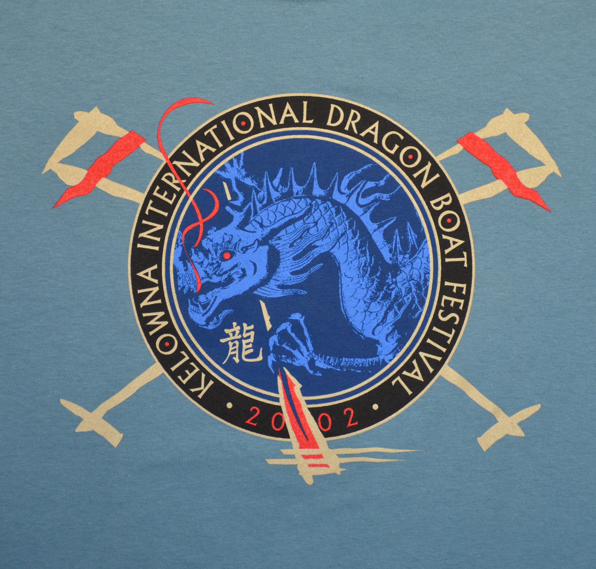 International Dragon Boat Festival logo displayed prominently on a blue shirt, showcasing vibrant colors and dynamic design.
