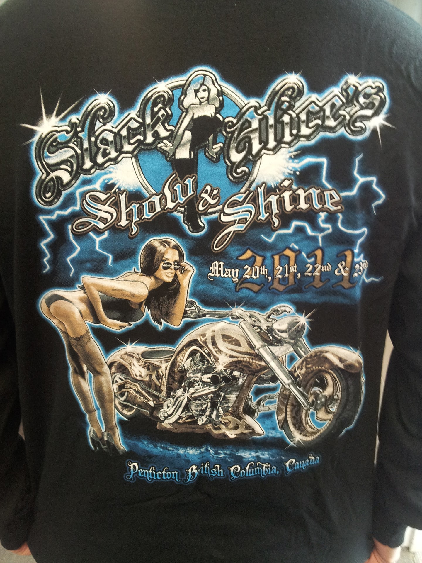 A man wearing a Show and Shine shirt featuring a woman riding a motorcycle.