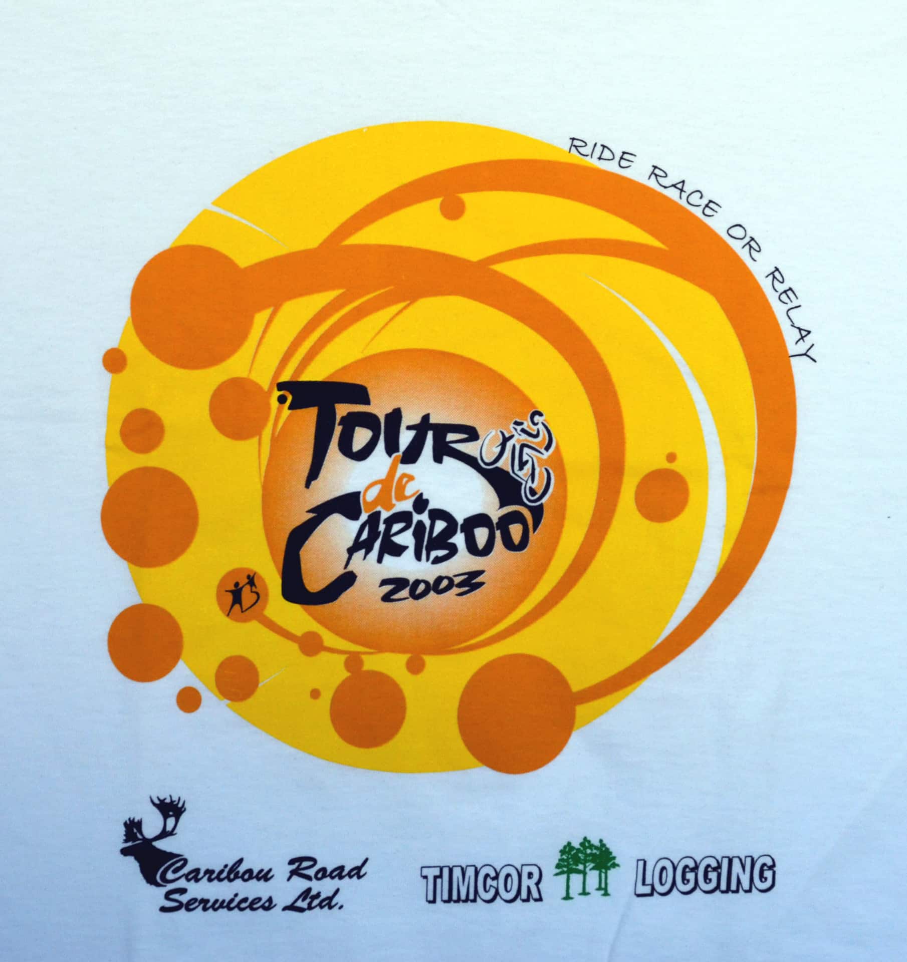 Tour De Cariboo shirt featuring a vibrant design with cycling graphics and the event name prominently displayed.